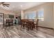 Bright dining area with a wooden table, wood-style floors, and open view to the kitchen at 30440 N 42Nd Pl, Cave Creek, AZ 85331