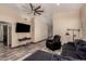 Comfortable living room with wood-style floors, a ceiling fan, and a relaxing recliner at 30440 N 42Nd Pl, Cave Creek, AZ 85331