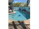 The uniquely shaped pool area is enhanced by desert landscaping, and a serene waterfall feature, for an enjoyable space at 30440 N 42Nd Pl, Cave Creek, AZ 85331