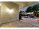 Covered patio area overlooking a pool with rock features and lush tropical landscaping at 3152 N 83Rd Pl, Scottsdale, AZ 85251