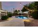 Relaxing backyard featuring a pool, rock waterfall, and mature trees for shade and privacy at 3152 N 83Rd Pl, Scottsdale, AZ 85251