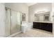 Bathroom featuring a glass shower, soaking tub, and a dual sink vanity at 3152 N 83Rd Pl, Scottsdale, AZ 85251