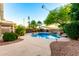 Inviting backyard pool with lush landscaping and decorative string lights for a serene outdoor experience at 3152 N 83Rd Pl, Scottsdale, AZ 85251