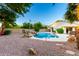 Backyard pool and spa featuring rock waterfall, ambient string lights, and low-maintenance desert landscaping at 3152 N 83Rd Pl, Scottsdale, AZ 85251
