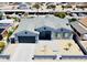 Charming light blue home with a large driveway and landscaped front yard, showcasing neighborhood views at 32101 W Palo Verde St, Wittmann, AZ 85361