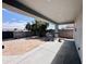 Covered patio overlooking a backyard with gravel landscaping and a block wall, creating a private outdoor space at 32101 W Palo Verde St, Wittmann, AZ 85361