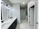 Bright bathroom featuring double vanity, modern fixtures, and walk-in shower at 32101 W Palo Verde St, Wittmann, AZ 85361