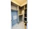 Spacious walk-in closet with built-in shelving and custom organizers at 32101 W Palo Verde St, Wittmann, AZ 85361