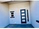 Covered entryway showcasing a modern door with sidelight at 32101 W Palo Verde St, Wittmann, AZ 85361