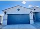 Spacious two-car garage featuring modern doors and exterior lighting at 32101 W Palo Verde St, Wittmann, AZ 85361