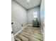 Bright laundry room with sink, washer and dryer hookups, and wood-look flooring for easy cleaning at 32101 W Palo Verde St, Wittmann, AZ 85361