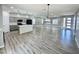 Spacious living room and kitchen area with modern lighting and wood-look flooring at 32101 W Palo Verde St, Wittmann, AZ 85361