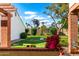 Spacious backyard featuring a green lawn, mature trees, and a unique globe structure at 34 Leisure World --, Mesa, AZ 85206