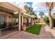 A backyard covered patio with artificial turf, landscaping, and patio seating at 34 Leisure World --, Mesa, AZ 85206