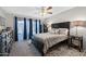 Primary bedroom with a ceiling fan and decorative, sheer curtains at 34 Leisure World --, Mesa, AZ 85206
