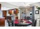 Open-concept dining area featuring stylish cabinetry, a modern table set, and backyard access at 34 Leisure World --, Mesa, AZ 85206