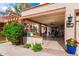 Inviting front porch with brick columns, terracotta accents, and a spacious outdoor seating area at 34 Leisure World --, Mesa, AZ 85206