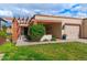 Charming single-story home featuring a well-manicured lawn, brick accents, and a cozy covered porch at 34 Leisure World --, Mesa, AZ 85206