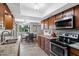 A traditional kitchen features granite countertops, tile floors, and stainless steel appliances at 34 Leisure World --, Mesa, AZ 85206