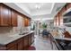 A traditional kitchen boasts granite countertops, tile floors, and stainless steel appliances at 34 Leisure World --, Mesa, AZ 85206