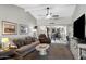 A cozy living room with a vaulted ceiling and ceiling fan flows into the adjacent dining area at 34 Leisure World --, Mesa, AZ 85206