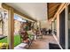 A covered patio with artificial turf and patio furniture creates a welcoming outdoor living space at 34 Leisure World --, Mesa, AZ 85206