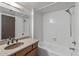 Bathroom with a white tiled shower and a granite vanity at 3407 E Pueblo Ave, Mesa, AZ 85204
