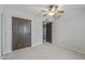 Bedroom featuring neutral carpet, ceiling fan, and double-door closets at 3407 E Pueblo Ave, Mesa, AZ 85204