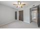 Bright bedroom with a ceiling fan, neutral walls, and a large closet at 3407 E Pueblo Ave, Mesa, AZ 85204