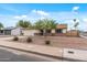 Street view of the house, showing the two-car garage, desert landscaping and proximity to the neighborhood at 3407 E Pueblo Ave, Mesa, AZ 85204