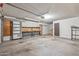 Spacious garage interior features a workbench, storage shelves, and a clean, functional layout at 3407 E Pueblo Ave, Mesa, AZ 85204
