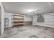 Clean garage interior with open space, overhead lighting, and exposed brick foundation at 3407 E Pueblo Ave, Mesa, AZ 85204