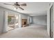 Cozy living room with a brick fireplace, access to the patio, and large windows for natural light at 3407 E Pueblo Ave, Mesa, AZ 85204