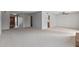 Spacious open floor plan with neutral carpet and a view to the entrance, kitchen, and fireplace at 3407 E Pueblo Ave, Mesa, AZ 85204