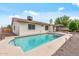 Sparkling pool with patio, lush landscaping, and a white brick house at 3407 E Pueblo Ave, Mesa, AZ 85204