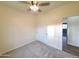 Bedroom with carpet, closet, ceiling fan, and view to hall at 350 N Florence St, Florence, AZ 85132