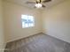 Well-lit bedroom with plush carpeting and a ceiling fan at 350 N Florence St, Florence, AZ 85132
