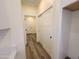 Hallway with access to white sliding door closets and a view to the home's entry door at 350 N Florence St, Florence, AZ 85132
