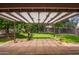 Covered patio with brick flooring overlooking a large backyard at 3556 E Angela Dr, Phoenix, AZ 85032