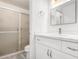 Bathroom featuring bright lighting, granite counters, a white vanity, and an updated shower with a glass enclosure at 3556 E Angela Dr, Phoenix, AZ 85032
