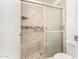 A renovated bathroom featuring a tiled shower with a built-in bench and modern fixtures at 3556 E Angela Dr, Phoenix, AZ 85032