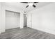 This bedroom features new gray floors, a closet, and is freshly painted at 3556 E Angela Dr, Phoenix, AZ 85032