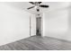 This bedroom features new gray floors, freshly painted walls and trim, and a ceiling fan at 3556 E Angela Dr, Phoenix, AZ 85032