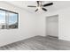 Bright bedroom features new gray floors, a closet, and ample natural light from a window at 3556 E Angela Dr, Phoenix, AZ 85032