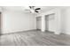 Spacious bedroom with gray flooring, a ceiling fan, and ample closet space for convenient storage solutions at 3556 E Angela Dr, Phoenix, AZ 85032