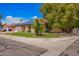 Well-maintained home featuring a green lawn and energy-efficient solar panels on the roof at 3556 E Angela Dr, Phoenix, AZ 85032
