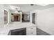 Beautiful kitchen with stainless dishwasher, quartz counters, and a view into the open living and Gathering room areas at 3556 E Angela Dr, Phoenix, AZ 85032
