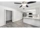 Bright living room showcasing an open floor plan, modern ceiling fan, and easy access to the kitchen and utility area at 3556 E Angela Dr, Phoenix, AZ 85032