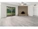 Spacious living room with gray floors, brick fireplace and sliding glass doors at 3556 E Angela Dr, Phoenix, AZ 85032