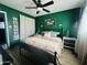 Beautifully decorated bedroom boasts stylish green walls and a ceiling fan at 3806 N 80Th Dr, Phoenix, AZ 85033